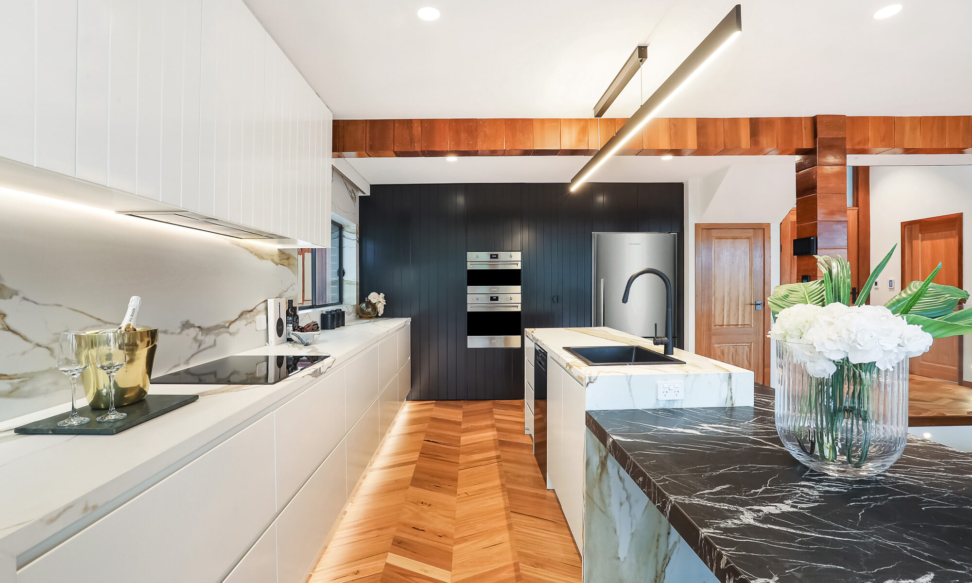 herringbone floor with marble and gold kitchen